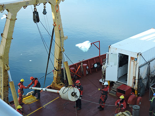 Déploiement d'un carottier à piston à bord de l’Amundsen permettant l’échantillonnage de carottes sédimentaires d’une longueur maximale de 9 m. (Photo : Maria-Emilia Rodriguez-Cuicas)